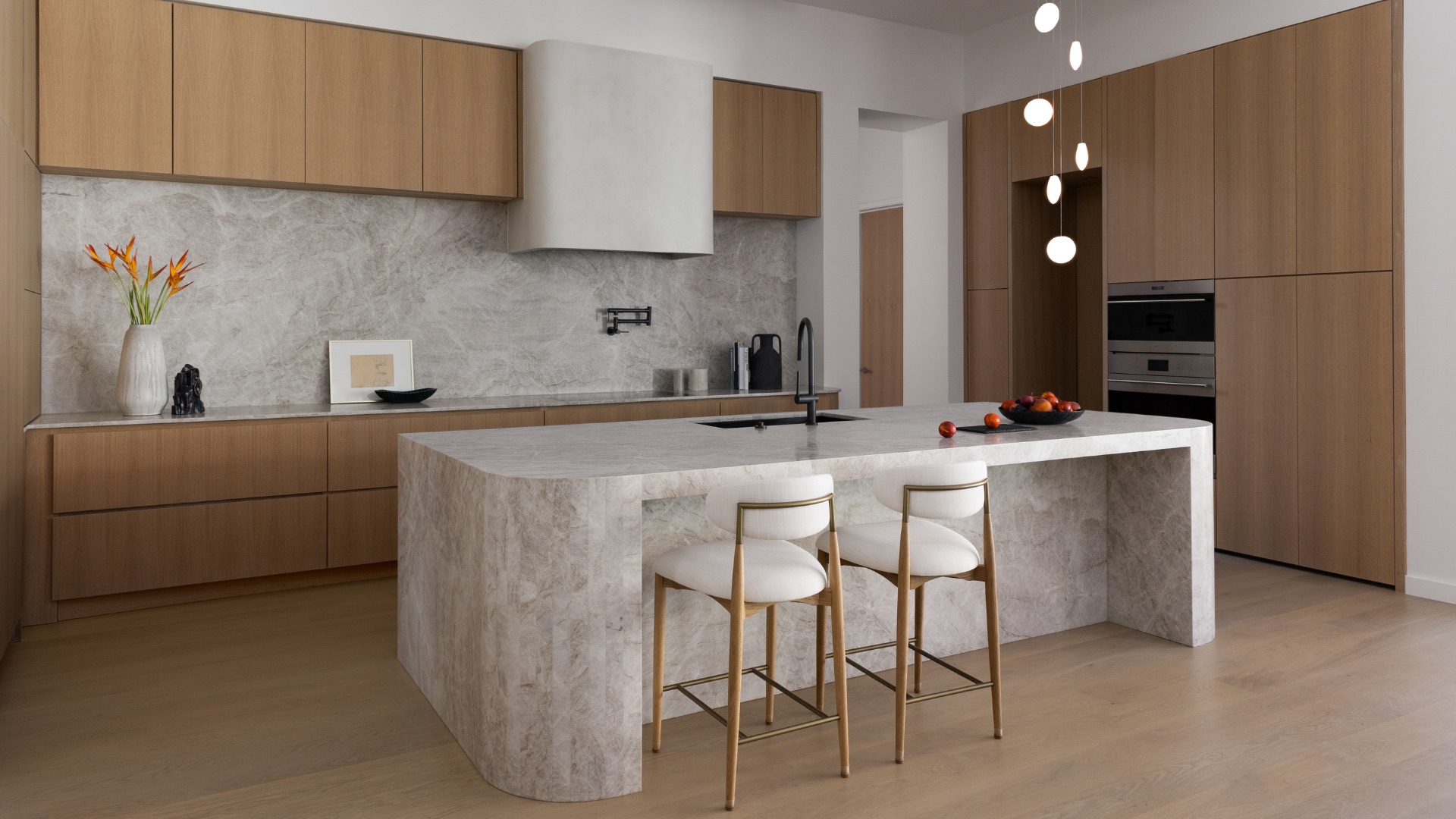 Finished kitchen with a waterfall-edge stone island