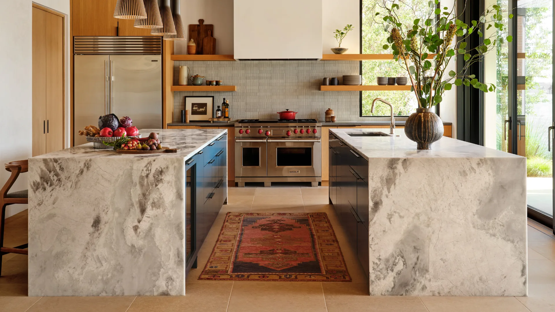 Finished kitchen with two waterfall-edge stone islands